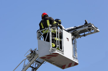 brave firefighters on the fire truck cage with the stretcher