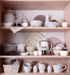Kitchen utensils and tableware on shelves