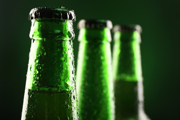 Glass bottles of beer on dark background