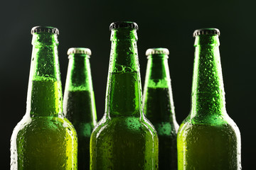 Glass bottles of beer on dark background