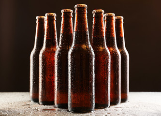 Glass bottles of beer on dark background
