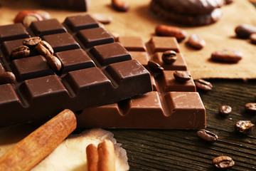 Delicious chocolates with nuts spices on table, closeup