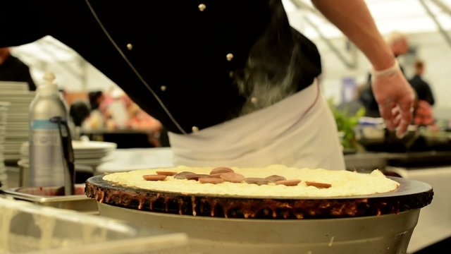 chef prepares a pancake - closeup - steam - chef in background