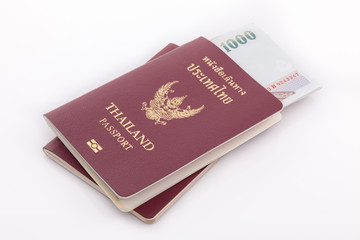 Thailand passport and Thai money for travel isolated on white ba