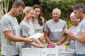Happy volunteer looking at donation box 