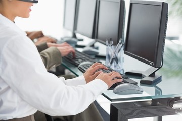 Business people with headsets using computers