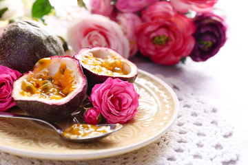 Passion fruit on plate on color wooden background