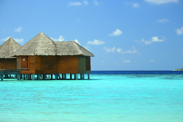 Water villas over ocean background