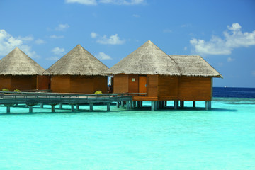 Water villas over ocean background