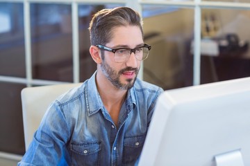 Casual businessman looking at computer screen