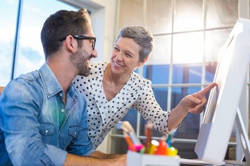 Casual businesswoman showing the screen to her partner