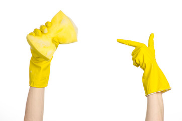 Hand holding a yellow sponge wet with foam  in studio gloves