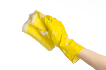 Hand holding a yellow sponge wet with foam isolated gloves