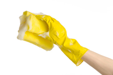 Hand holding a yellow sponge wet with foam isolated gloves