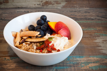 Breakfast muesli made with Greek yogurt and topped with fresh nectarines, blueberries, coconut and goji berries. Packed with vitamins this homemade muesli a healthy and nutritious start to the day.