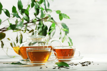 Cups of green tea on table on wooden background
