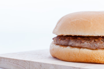 Close up of hamburger on block wood.