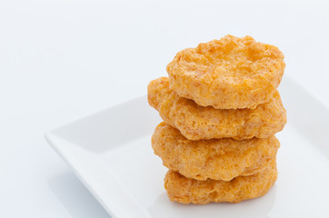 Group of fried chicken nuggets on white dish