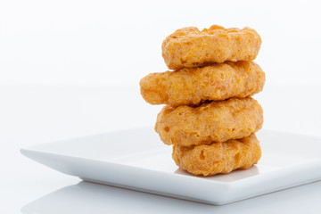 Group of fried chicken nuggets on white dish