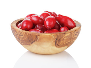 fresh bogwood berries in wood bowl isolated on white