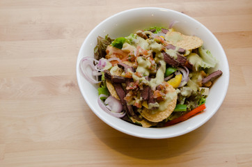 Grilled beef salad with tomato, potato, onion