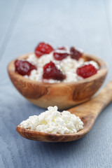 cottage cheese with preserved strawberry on blue table