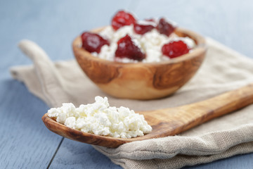 cottage cheese with preserved strawberry on blue table,