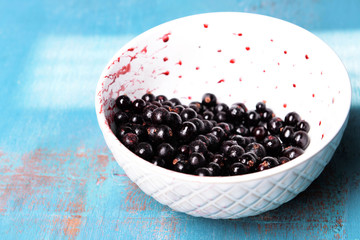 Blackberry in bowl on wooden background