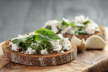 rye sandwich or bruschetta with ricotta, herbs and basil