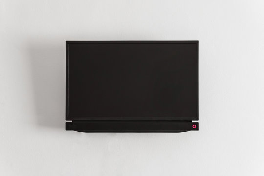Black LCD or LED tv screen hanging on a wall