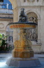 Fototapeta na wymiar Old fountain in the courtyard of town hall, Lyon, France