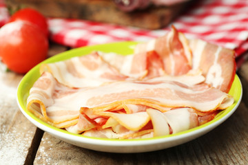 Tasty bacon on plate on table close up