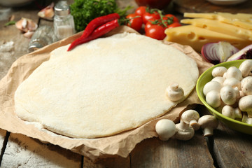 Food ingredients for pizza on table close up