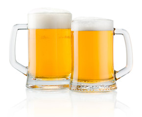 Two mug of fresh beer with cap of foam isolated on white backgro