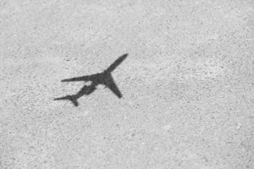 Shadow of model plane over asphalt background