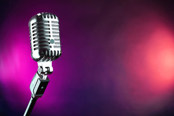 Retro microphone on colorful blurred background