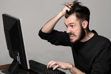 Funny and crazy man using a computer