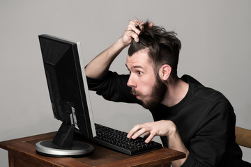 Funny and crazy man using a computer
