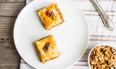 pieces of baklava with honey and nuts, top view, rustic