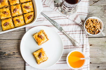 pieces of baklava with honey and nuts, top view, rustic