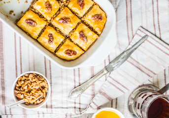 pieces of baklava with honey and nuts, top view, rustic