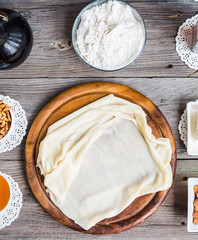 Ingredients for making homemade baklava,phyllo dough, nuts, hone