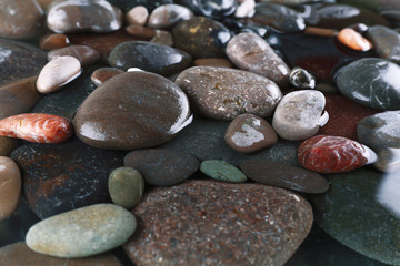 Wet sea pebbles background