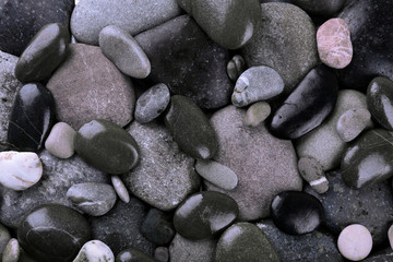 Fototapeta na wymiar Wet sea pebbles background