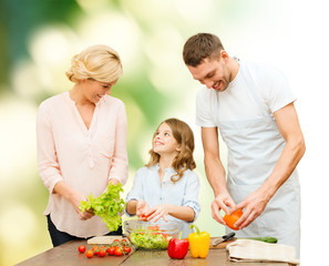 happy family cooking vegetable salad for dinner