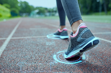 close up of woman feet running on track from back