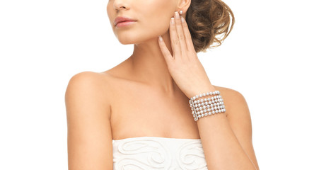 woman with pearl earrings and bracelet