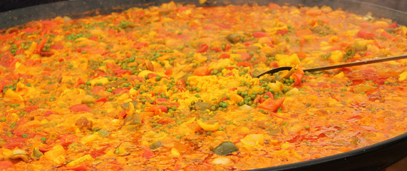 Freshly Made Paella Being Cooked in a Large Open Pan.