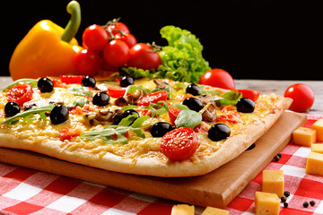 Delicious homemade pizza on table on black background