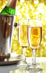 Glasses of champagne on bright background